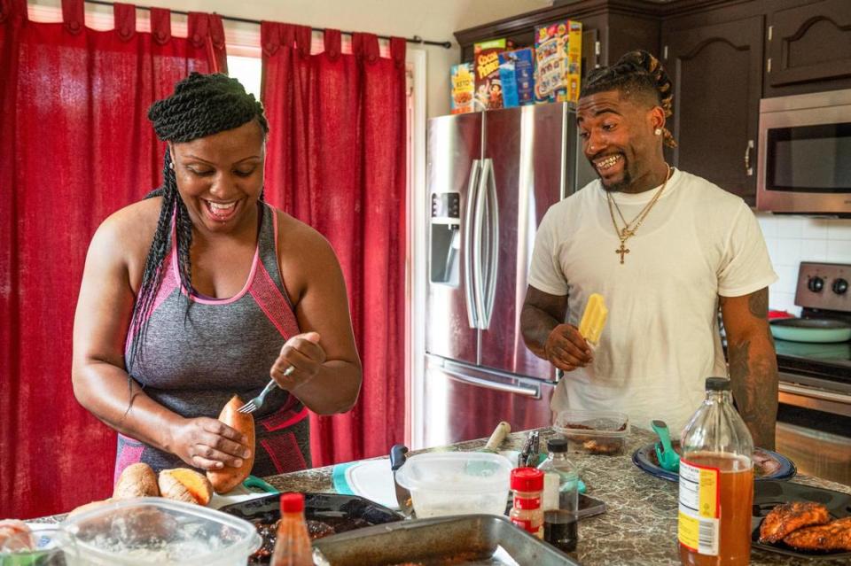Mika Roddy and John Roddy share a laugh while she prepares dinner at their home in Blue Springs. Zachary Linhares/The Kansas City Star