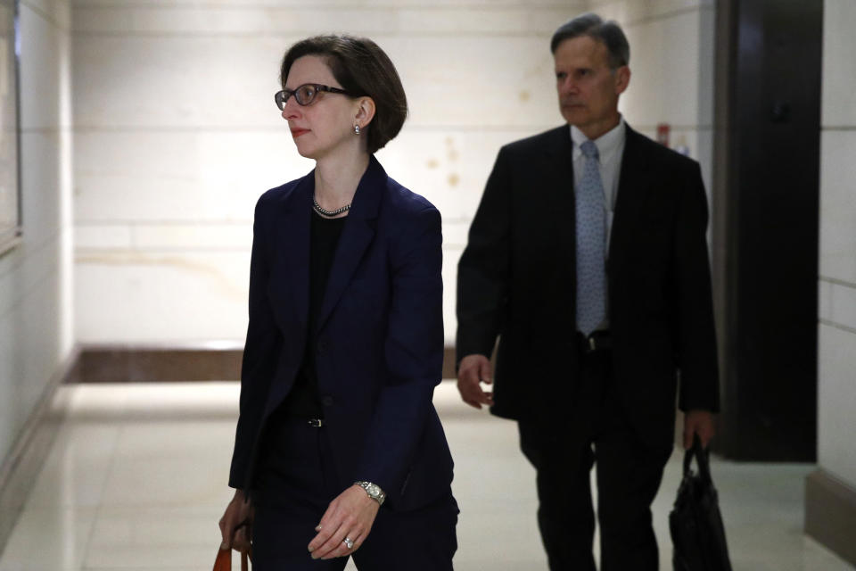 Deputy Assistant Secretary of Defense Laura Cooper, left, arrives to review her testimony as part of the House impeachment inquiry into President Donald Trump, Wednesday, Oct. 30, 2019, on Capitol Hill in Washington. (AP Photo/Patrick Semansky)