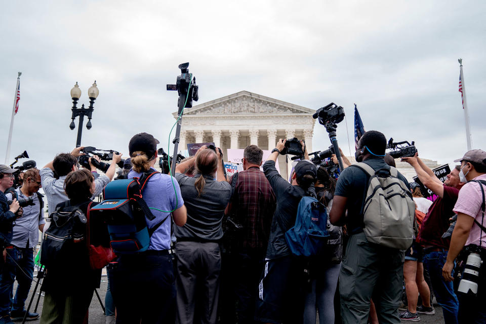 Members of the media gather around anti-abortion and abortion activists demonstrating outside the Supreme Court in Washington, on June 21, 2022.<span class="copyright">Stefani Reynolds—AFP/Getty Images</span>