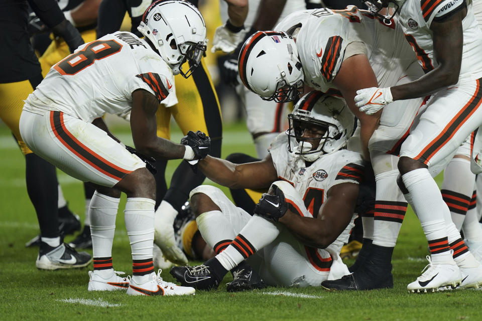 Cleveland Browns running back Nick Chubb, center, is helped up by teammates after an injury during the first half of an NFL football game against the Pittsburgh Steelers Monday, Sept. 18, 2023, in Pittsburgh. (AP Photo/Matt Freed)
