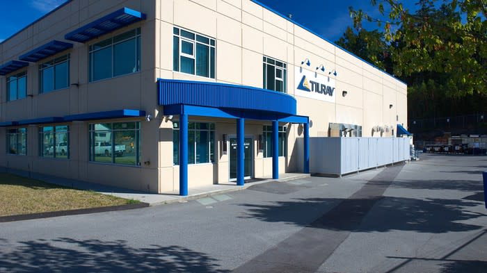 Beige and blue two-story building with Tilray logo on the side.