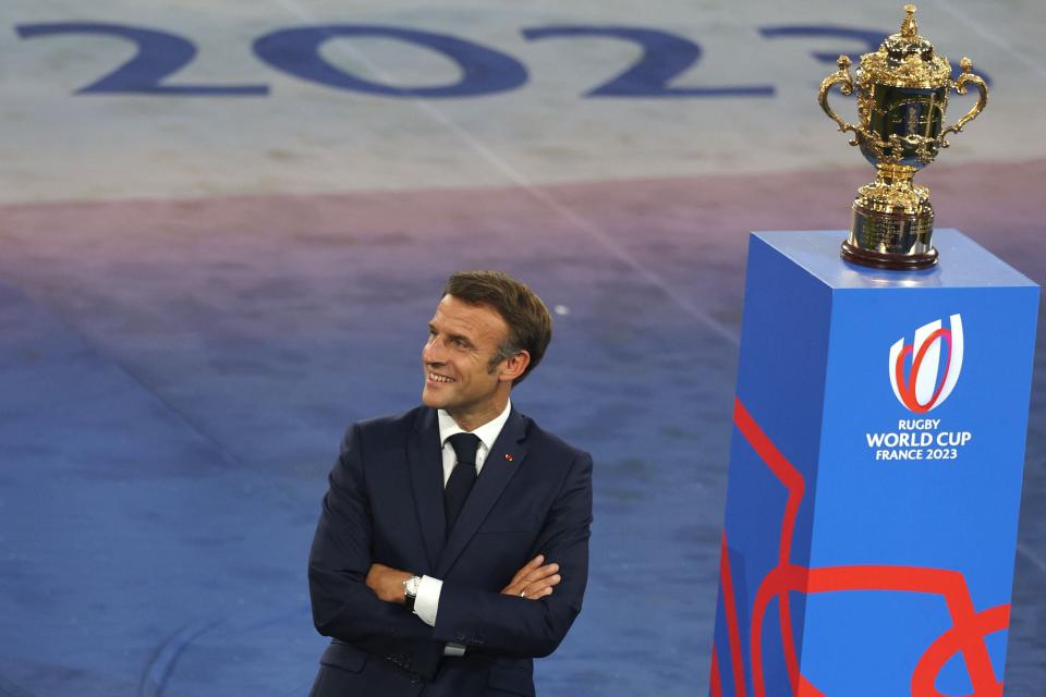 President Macron stands beside the Webb Ellis Trophy (AFP via Getty Images)