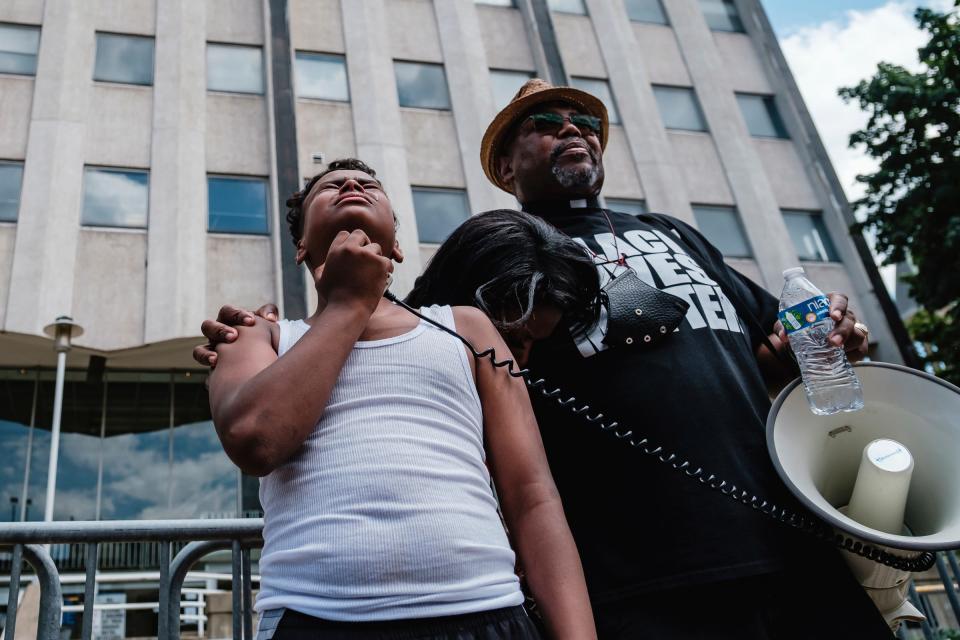 Javon Williams, 13, is comforted as he speaks during a march and rally for Jayland Walker. Javon had just viewed video released by police detailing the shooting death of Walker, who was unarmed when Akron, Ohio, police killed him in a hail of bullets after a car and foot chase.