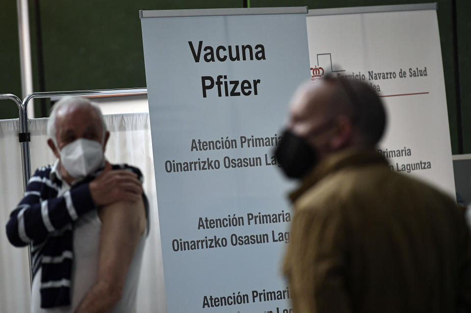 Jesus Garcia Beitia, 76, left, wait to receives a shot of Pfizer vaccine during a COVID-19 vaccination campaign, in Pamplona, northern Spain, Friday, May 7, 2021.(AP Photo/Alvaro Barrientos)