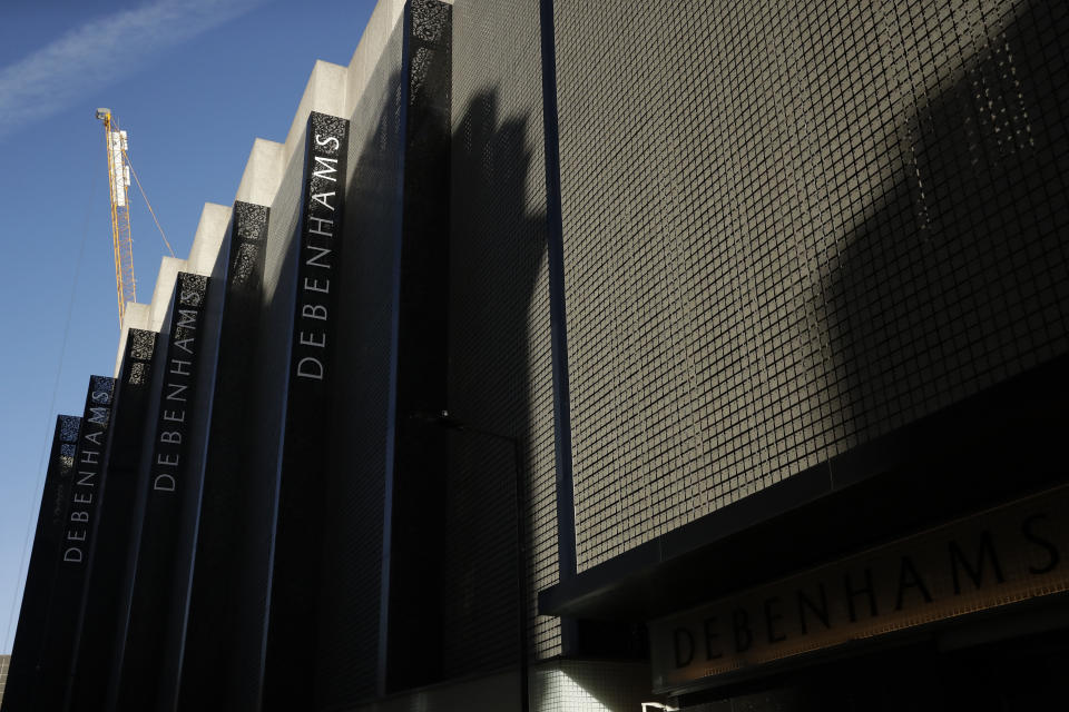 The Debenhams name is displayed at the Debenhams flagship department store on a side street off Oxford Street, during England's second coronavirus lockdown in London, Tuesday, Dec. 1, 2020. In another dark day for the British retailing industry, Debenhams said Tuesday it will start liquidating its business after a potential buyer of the company pulled out, a move that looks like it will cost 12,000 workers their jobs. (AP Photo/Matt Dunham)