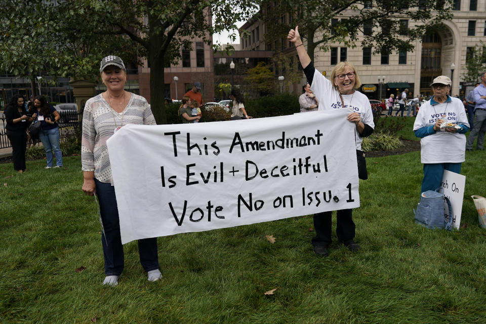 People gather during the Ohio March for Life rally, at the Ohio State House in Columbus, Ohio, Friday, Oct. 6, 2023. Their sign reads "This Amendment Is Evil and Deceitful Vote No and Issue 1." As campaigning escalates in Ohio’s fall fight over abortion rights, a new line of attack from opponents suggests “partial-birth” abortions would be revived if a proposed constitutional amendment passes. (AP Photo/Carolyn Kaster)