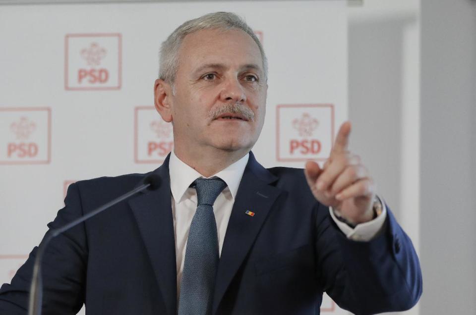 In this photo taken on Wednesday, Dec. 7, 2016, Liviu Dragnea, the leader of the Social Democratic party smiles during a press conference in Bucharest, Romania. Since Premier Dacian Ciolos appeared open-collared and sans cravat in recent television interviews, there have been clucks of disapproval. Ciolos has not explained this new look, but he's the first Romanian prime minister to create a stir with his lack of formal wear while, in contrast, political opponent Liviu Dragnea, who is chairman of the Social Democrats, has worn a plain red or blue tie in pre-election appearances. (AP Photo/Vadim Ghirda)