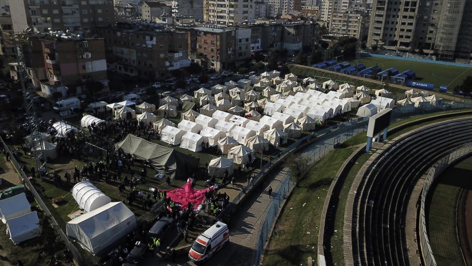 A general view of a makeshift camp at a soccer field in Durres, western Albania, Wednesday, Nov. 27, 2019. The death toll from a powerful earthquake in Albania has risen to 25 overnight as local and international rescue crews continue to search collapsed buildings for survivors. (AP Photo/Hektor Pustina)