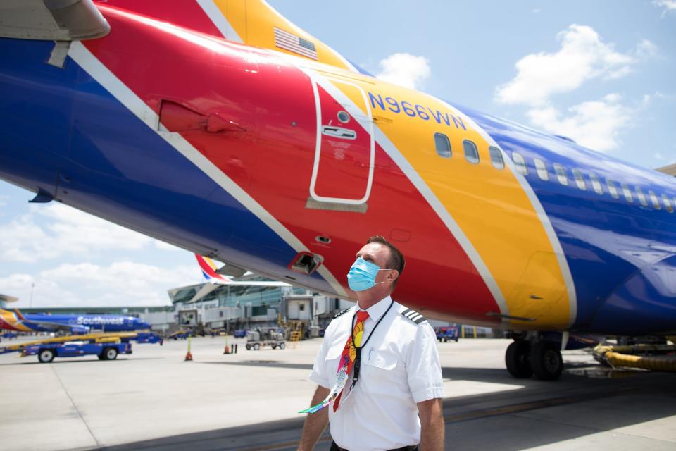 A Southwest Airlines pilot outside one of the airplane's Boeing 737s.