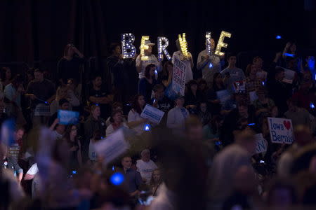 Supporters of Democratic presidential candidate Bernie Sanders hold a sign supporting him as he speaks during the 2015 Jefferson-Jackson Dinner with fellow candidates Hillary Clinton and Martin O'Malley in Des Moines, Iowa, October 24, 2015. REUTERS/Scott Morgan