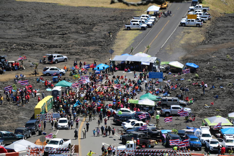In this Sunday, July 21, 2019, photo provided by the Hawaii Department of Land and Natural Resources, protesters block a road to the summit of Mauna Kea in Hawaii. Scientists want to build the telescope atop Mauna Kea because it is one of the best sites in the world for viewing the skies. Hawaii Gov. David Ige has ordered the closure of the road as a way to clear a path for construction equipment. (Dan Dennison/Hawaii Department of Land and Natural Resources via AP)