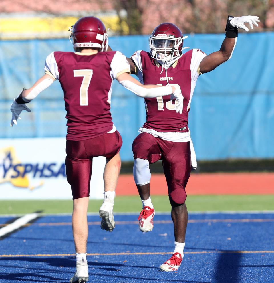 O'Neill's Jordan Thompson (13) celebrates his first-half touchdown against Warrensburg with teammate Thor Swanson (7) during the Class C state semifinal at Middletown High School Nov. 26, 2022.