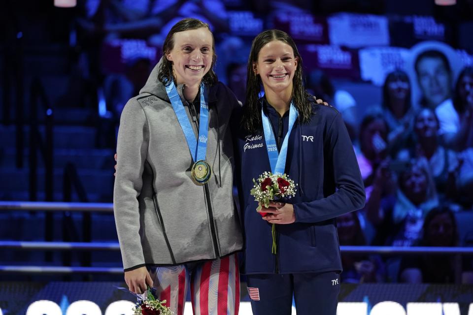 Katie Ledecky and Katie Grimes on the podium at the medal ceremony for the women's 800 freestyle during wave 2 of the U.S. Olympic Swim Trials on Saturday, June 19, 2021, in Omaha, Neb. (AP Photo/Charlie Neibergall)