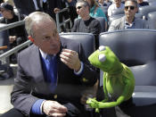 New York Mayor Michael Bloomberg, left, shares snacks with Kermit the Frog during the Yankees home opener baseball game against the Los Angeles Angels at Yankee Stadium in New York, Friday, April 13, 2012. (AP Photo/Kathy Willens)