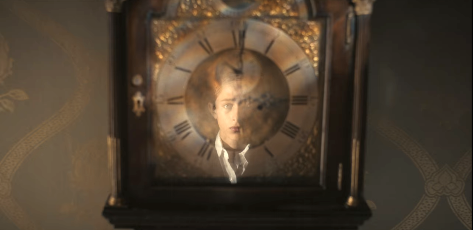 close up of the clock with henry's reflection