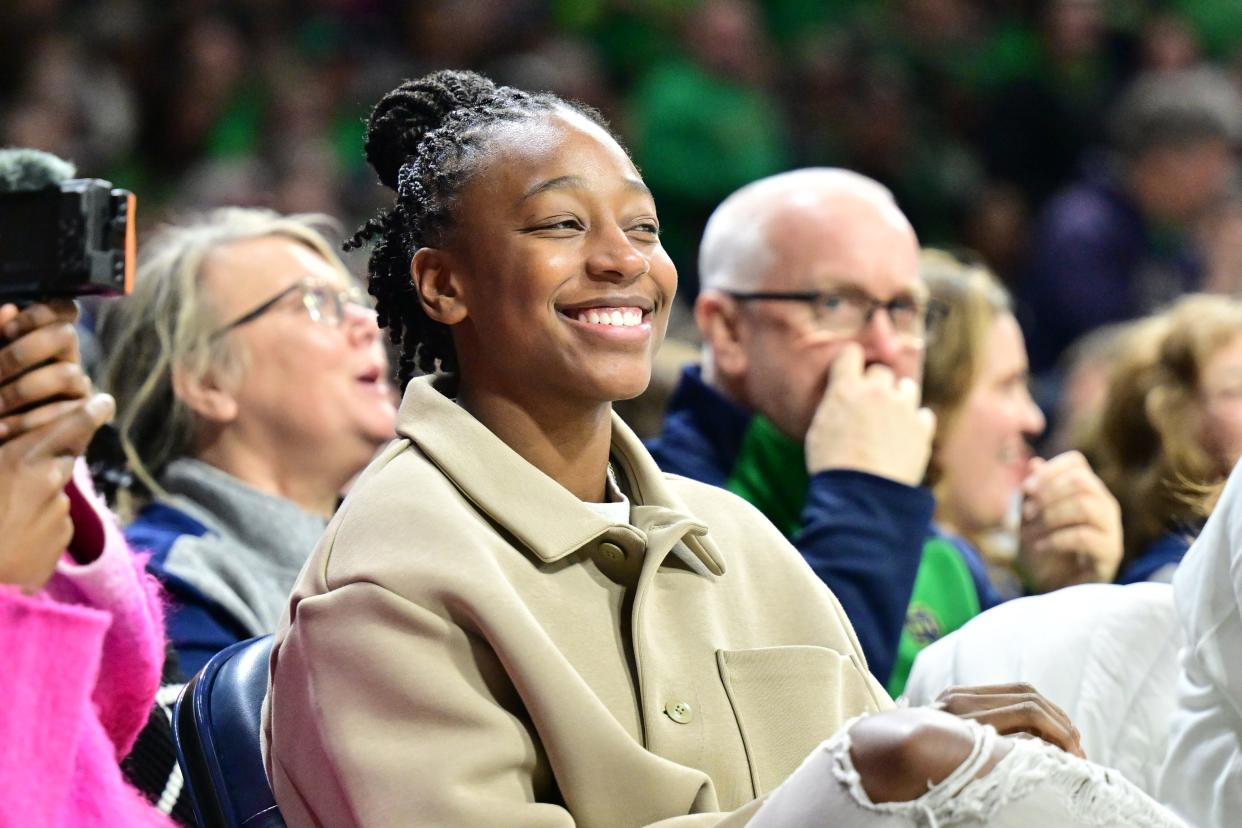 Feb 29, 2024; South Bend, Indiana, USA; WNBA Seattle Storm player Jewell Loyd smiles as she watches in the first half of the game between the Notre Dame Fighting Irish and the Virginia Tech Hokies at the Purcell Pavilion. Mandatory Credit: Matt Cashore-USA TODAY Sports