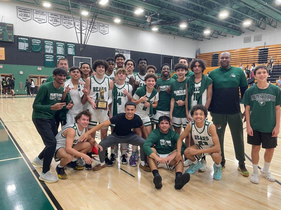 The Palmetto Ridge boys basketball team poses for pictures after capturing the 8-team Palmetto Ridge Holiday Hoops Tournament on Thursday, Dec. 22, 2022. The Bears beat Lely, 58-50.