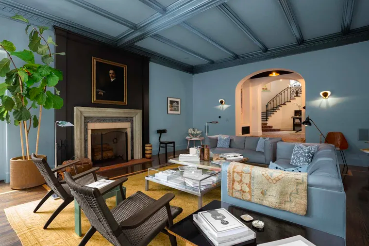 blue living room with black fireplace feature and blue sofas