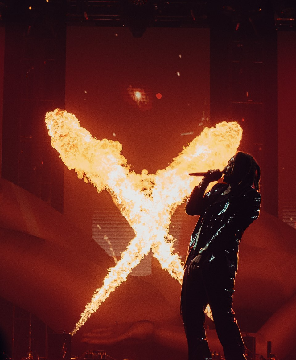 Future performing with flames behind him.