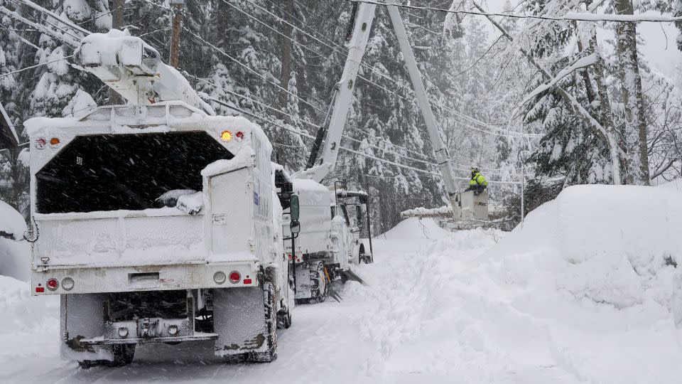 Crews clear trees along Donner Lake, where power was lost due to the storm Saturday, March 2, in Truckee, California. - Brooke Hess-Homeier/AP