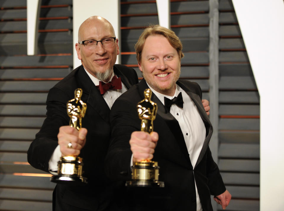 Roy Conli, left, and Don Hall pose backstage with their award for best animated feature film for “Big Hero 6” arrives at the 2015 Vanity Fair Oscar Party on Sunday, Feb. 22, 2015, in Beverly Hills, Calif. (Photo by Evan Agostini/Invision/AP)