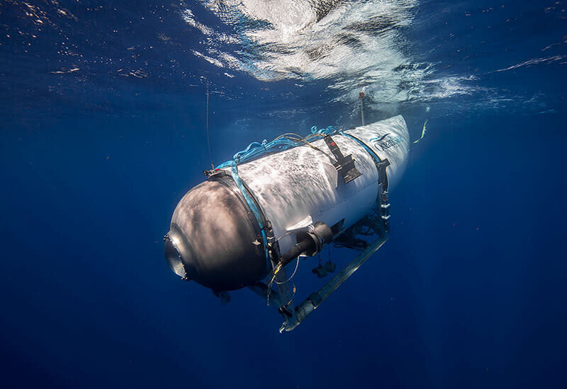 The Titan submersible heads down, porthole first and cone at the rear, just under the ocean surface.