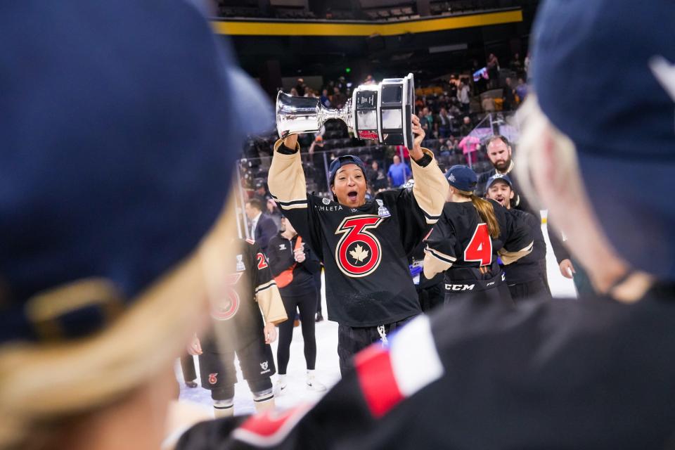 Toronto Six defenseman Saroya Tinker (71) lifts the Isobel Cup as the Toronto Six celebrate winning the Isobel Cup final against the Minnesota Whitecaps at the Mullett Arena on Sunday, March 26, 2023, in Tempe.