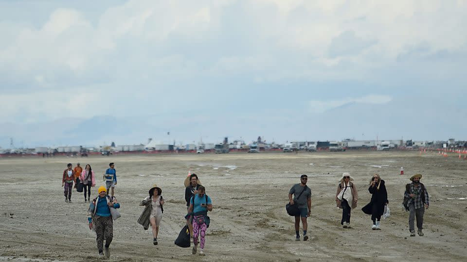 People walk off the playa out near the Burning Man site on the Black Rock Desert in northern Nevada on Sunday.  - Jason Bean/RGJ/USA TODAY/Reuters