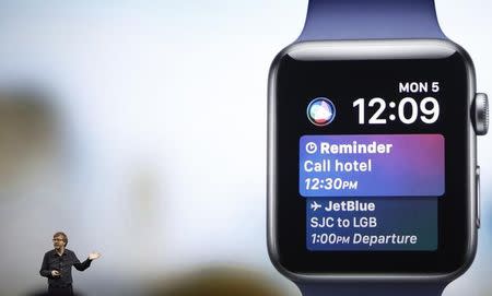 Kevin Lynch, VP of Technology at Apple, speaks near a projection of an Apple Watch during the company's annual world wide developer conference (WWDC) in San Jose, California, U.S. June 5, 2017. REUTERS/Stephen Lam