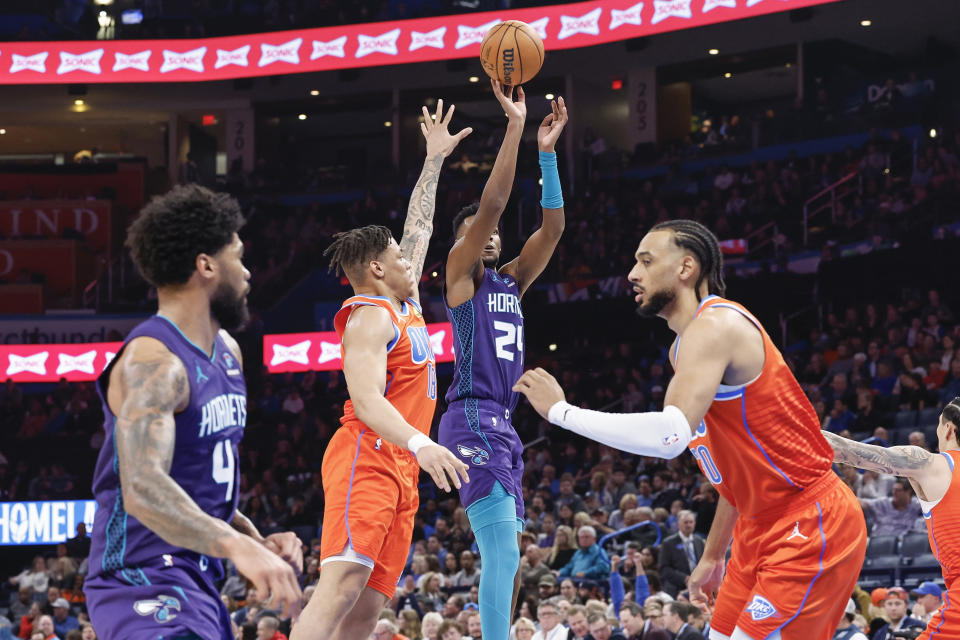 Feb 2, 2024; Oklahoma City, Oklahoma, USA; Charlotte Hornets forward Brandon Miller (24) shoots as Oklahoma City Thunder forward <a class="link " href="https://sports.yahoo.com/nba/players/10071/" data-i13n="sec:content-canvas;subsec:anchor_text;elm:context_link" data-ylk="slk:Keyontae Johnson;sec:content-canvas;subsec:anchor_text;elm:context_link;itc:0">Keyontae Johnson</a> (18) defends the shot during the second half at Paycom Center. Mandatory Credit: Alonzo Adams-USA TODAY Sports