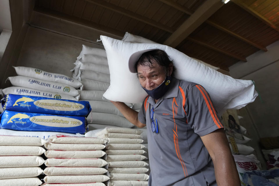 A worker carries a rice sack in Bangkok, Thailand, on Thursday, Aug. 10, 2023. Countries worldwide are scrambling to secure rice after a partial ban on exports by India cut supplies by roughly a fifth. The lack of clarity about what India will do next and concerns about the El Nino means Thai exporters are reluctant to take orders, mill operators are unwilling to sell and farmers have increased the prices of unmilled rice, said the president of the Thai Rice Exporters Association. (AP Photo/Sakchai Lalit)