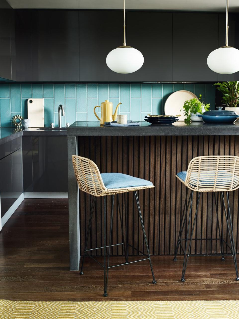 kitchen island with bar stools and blue tiles