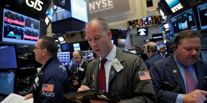 Traders work on the trading floor at the opening of the markets at the New York Stock Exchange (NYSE) in Manhattan, New York City, U.S., February 27, 2017. REUTERS/Andrew Kelly    