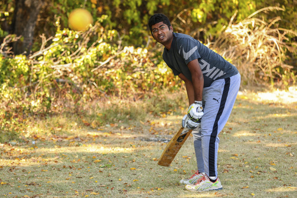 Suresh Bukkara Nagaraju warms up during a cricket match between the Dallas Cricket Connections and the Kingswood Cricket Club on a field adjacent to Roach Middle School in Frisco, Texas, Saturday, Oct. 22, 2022. The teams play in the City of Frisco Cricket league. (AP Photo/Andy Jacobsohn)