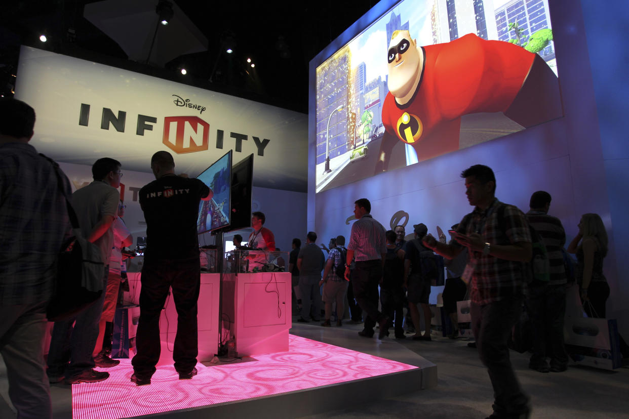 People visit the Disney Infinity exhibit at E3, the Electronic Entertainment Expo, in Los Angeles, California, June 11, 2013.    REUTERS/David McNew (UNITED STATES - Tags: SCIENCE TECHNOLOGY SOCIETY BUSINESS)