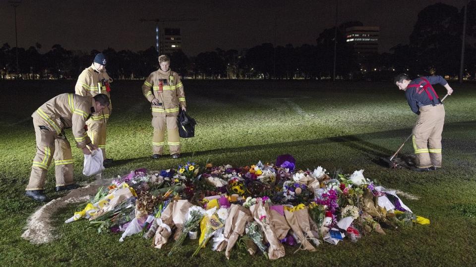 Fire crews work to remove the graffiti at the memorial site where Melbourne woman Eurydice Dixon was murdered. Source AAP