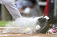 Chicago White Sox catcher Martín Maldonado reaches for a pitch from starter Mike Clevinger in the dirt past the foot of Cleveland Guardians' José Ramírez during the first inning of a baseball game Saturday, May 11, 2024, in Chicago. (AP Photo/Charles Rex Arbogast)