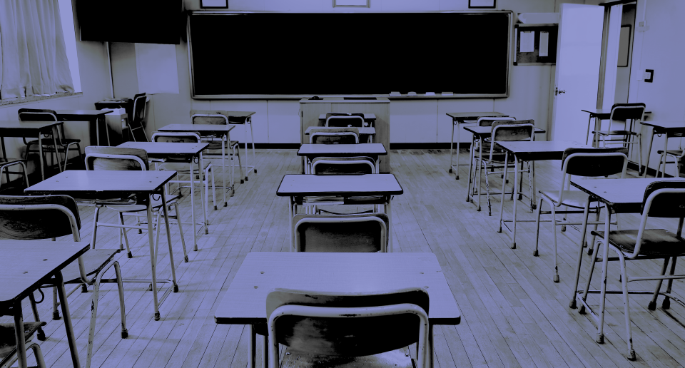 An empty classroom at school with a purple-ish tint