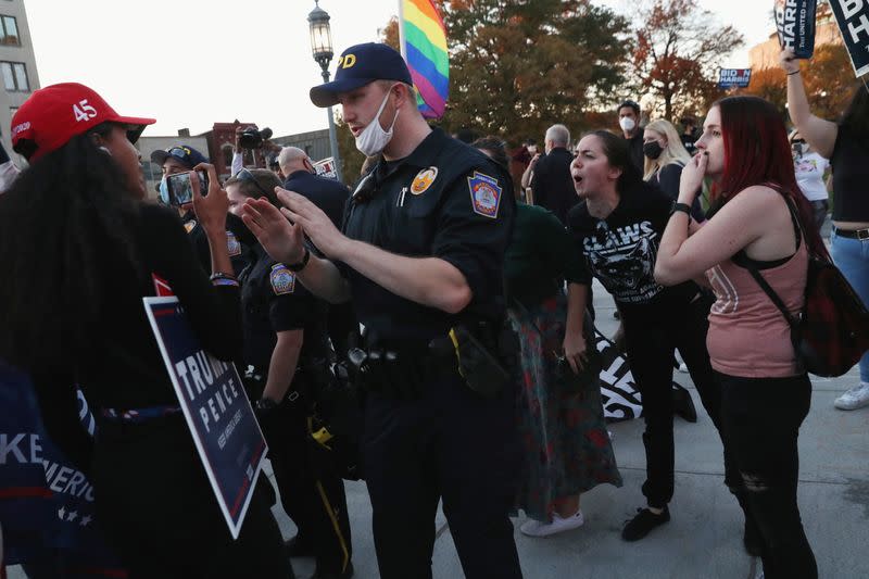 Supporters of U.S. President Donald Trump face off with supporters of Democratic candidate Joe Biden outside the State Capitol building after news media declared Joe Biden to be the winner of the 2020 U.S. presidential election, in Harrisburg