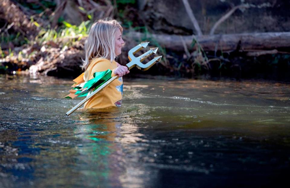 Bodhi Tennis, 11, wades into Penns Creek before diving underwater for the YMCA of Centre County Polar Bear Plunge on Saturday.