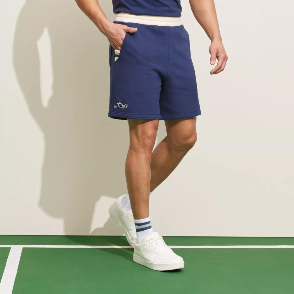 model wearing blue fleece shorts with white sneakers