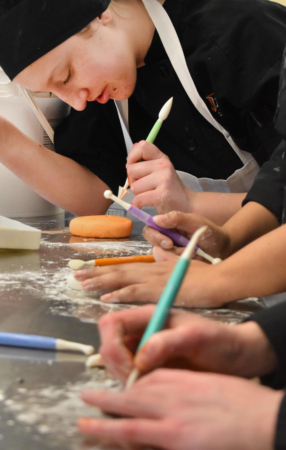 Arianna Chase works with fondant at Diman as practice ahead of the annual Massachusetts ProStart Student Invitational at Gillette Stadium in Foxboro.