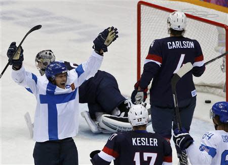 Finland's Teemu Selanne (L) celebrates his goal as Team USA's Ryan Kesler and John Carlson react during the third period of their men's ice hockey bronze medal game at the Sochi 2014 Winter Olympic Games February 22, 2014. REUTERS/Grigory Dukor