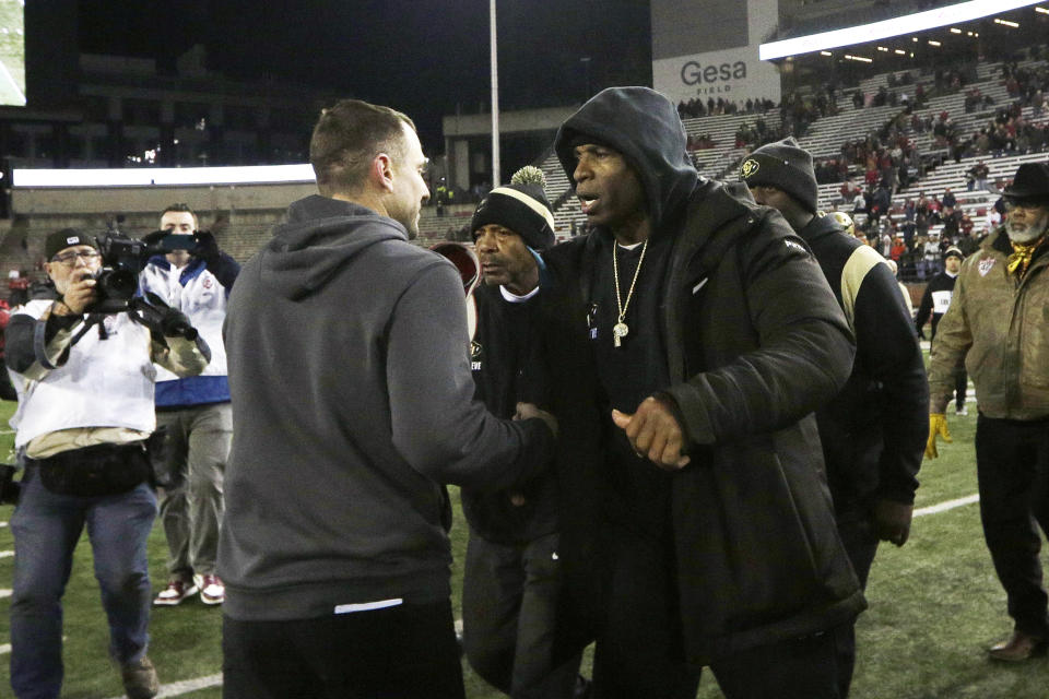 Washington State head coach Jake Dickert, left, and Colorado head coach Deion Sanders greet each other after an NCAA college football game, Friday, Nov. 17, 2023, in Pullman, Wash. Washington State won 56-14. (AP Photo/Young Kwak)