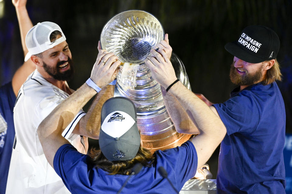 TAMPA, FLORIDA - SEPTEMBER 30: Steven Stamkos #91 and Alex Killorn #17 pour beer out of the Stanley Cup for Victor Hedman #77 of the Tampa Bay Lightning during the 2020 Stanley Cup Champion rally on September 30, 2020 in Tampa, Florida. (Photo by Douglas P. DeFelice/Getty Images)