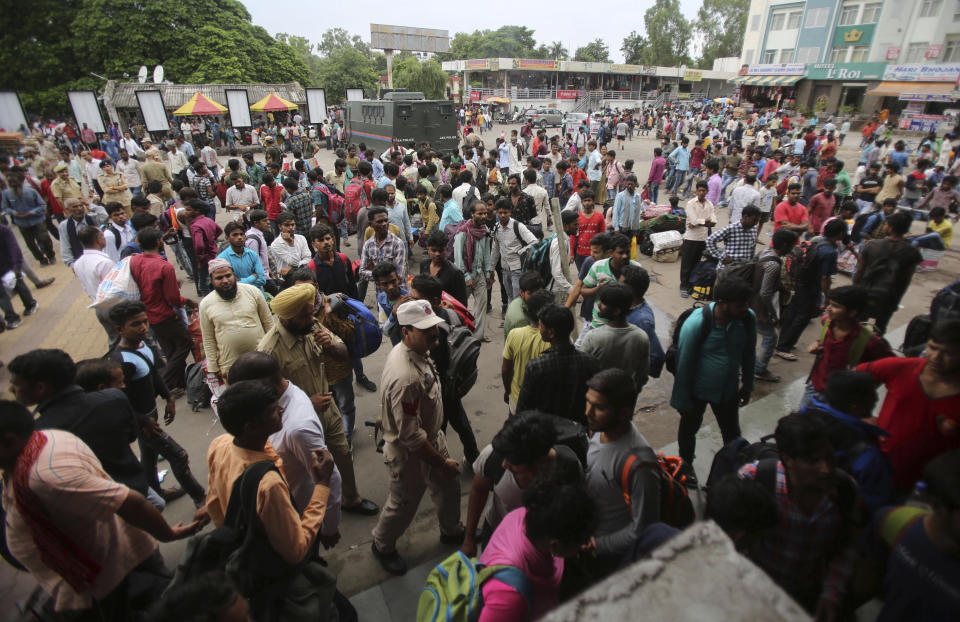 Indian migrant laborers carry their luggage and prepare to leave the region, at a railway station in Jammu, India, Wednesday, Aug. 7, 2019. Indian lawmakers passed a bill Tuesday that strips statehood from the Indian-administered portion of Muslim-majority Kashmir, which remains under an indefinite security lockdown, actions that archrival Pakistan warned could lead to war. (AP Photo/Channi Anand)