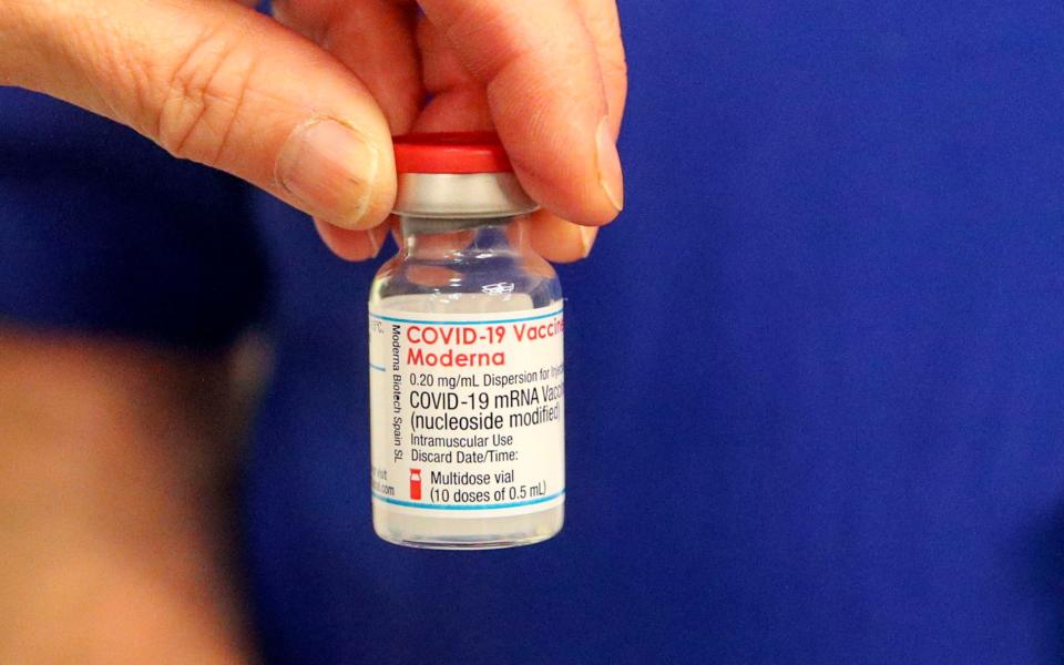 A vial of the Moderna Covid-19 vaccine is prepared at the vaccination centre at the Madejski Stadium in Reading, Berkshire
