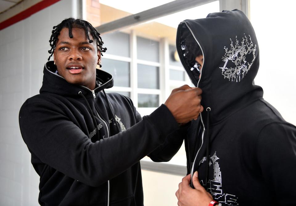 Vineland High School senior Antwain Rivera, left, shows off his latest Strive or Starve hoodie design with his friend Daeshaun Winchester on Thursday, May 12, 2022.