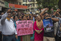 Members of Communist Party of India shout slogans during a protest against farm laws in Mumbai, India Monday, Sept. 27, 2021. The farmers called for a nation-wide strike Monday to mark one year since the legislation was passed, marking a return to protests that began over a year ago. (AP Photo/Rafiq Maqbool)