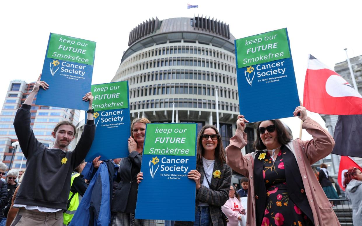 Critics of Luxon have campaigned against his policies on tobacco outside the New Zealand Parliament in Wellington, Dec 2023